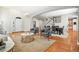 Open concept living space with hardwood floors, arched doorways, and staircase access at 7527 E Severn Pl, Denver, CO 80230