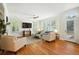 Spacious living room features hardwood floors, plantation shutters, and access to the deck at 7527 E Severn Pl, Denver, CO 80230