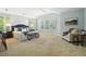 Spacious main bedroom featuring a cozy sitting area, neutral color palette, and plantation shutters at 7527 E Severn Pl, Denver, CO 80230