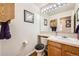 Well-lit powder room with a single sink and wood-framed mirror at 6172 S Salida Ct, Aurora, CO 80016