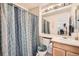 Bright bathroom featuring a shower-tub combo, a large vanity, and neutral finishes at 6172 S Salida Ct, Aurora, CO 80016