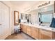 Bathroom with dual sinks, neutral countertops, and decorative mirrors at 6172 S Salida Ct, Aurora, CO 80016