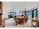 Open-concept dining room with stylish furnishings, chandelier, and view into the living room at 6172 S Salida Ct, Aurora, CO 80016