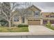 Two-story home featuring a tan exterior, a two-car garage, and a well-maintained front yard at 6172 S Salida Ct, Aurora, CO 80016