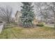 Home featuring a lush lawn with mature shade trees and wood fence at 6172 S Salida Ct, Aurora, CO 80016