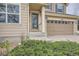 Close up of the front door and garage featuring well maintained landscaping at 6172 S Salida Ct, Aurora, CO 80016