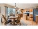 Sunny kitchen with hardwood floors, eat-in table, and sliding glass door to backyard at 6172 S Salida Ct, Aurora, CO 80016