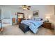 Spacious bedroom with neutral carpet, dresser, window, and comfortable queen sized bed at 6172 S Salida Ct, Aurora, CO 80016