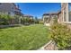 Expansive backyard featuring a well-maintained lawn, mature trees, and a charming wooden fence for privacy at 22198 Boundstone Dr, Parker, CO 80138