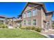 Spacious backyard with manicured lawn, featuring an outdoor fireplace, patio area, and lush landscaping for relaxation at 22198 Boundstone Dr, Parker, CO 80138
