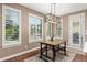 Charming dining area with modern light fixture and backyard views at 22198 Boundstone Dr, Parker, CO 80138