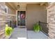 Inviting front porch with a wreath, potted ferns, and a 'hello' welcome mat at 22198 Boundstone Dr, Parker, CO 80138