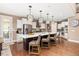 Modern kitchen with a large island, white cabinetry, and stainless steel appliances at 22198 Boundstone Dr, Parker, CO 80138
