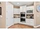 Bright kitchen featuring white cabinetry, stainless steel appliances, and hardwood floors at 22198 Boundstone Dr, Parker, CO 80138
