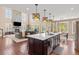 Open-concept living space with a large island, fireplace, and abundant natural light at 22198 Boundstone Dr, Parker, CO 80138