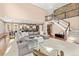 Open-concept living space with a view of the staircase and seamless transition to the kitchen at 22198 Boundstone Dr, Parker, CO 80138