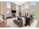 Spacious living room with a stone fireplace, large windows, and comfortable seating at 22198 Boundstone Dr, Parker, CO 80138