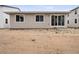 Exterior showcasing home's backyard with sliding glass doors leading to a spacious, unfinished lot at 45946 Gentry Ave, Bennett, CO 80102