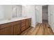 Bathroom features double vanity with white countertop, wood cabinets and glass shower stall at 45946 Gentry Ave, Bennett, CO 80102
