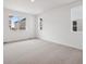 Spacious bedroom with plush carpeting and plenty of natural light from the windows at 45946 Gentry Ave, Bennett, CO 80102