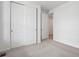 Bedroom featuring plush carpeting, double closets, neutral paint and a doorway to an adjoining room at 45946 Gentry Ave, Bennett, CO 80102