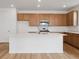 Beautiful kitchen featuring a large island, stainless steel appliances, and ample cabinet space at 45946 Gentry Ave, Bennett, CO 80102
