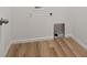 A practical laundry area showcasing durable, wood-look flooring, and easy-access utility connections at 45946 Gentry Ave, Bennett, CO 80102