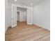 Room with luxury vinyl floors, recessed lights, and bright walls connected to another room by glass French doors at 45946 Gentry Ave, Bennett, CO 80102