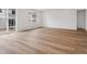 Bright living room with wood-look floors and large sliding glass doors to the backyard at 45946 Gentry Ave, Bennett, CO 80102
