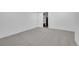 Bright unfinished basement area features neutral carpet and a white interior door at 17336 E Rice Cir # F, Aurora, CO 80015