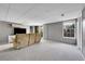 Finished basement with neutral carpet and a tan reclining sofa at 17336 E Rice Cir # F, Aurora, CO 80015
