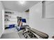 Unfinished basement with fitness equipment, storage shelves and carpet at 17336 E Rice Cir # F, Aurora, CO 80015