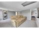 Finished basement with neutral carpet and a comfortable tan reclining sofa at 17336 E Rice Cir # F, Aurora, CO 80015