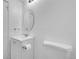 Clean half-bathroom with white sink, toilet, oval mirror, and silver fixtures at 17336 E Rice Cir # F, Aurora, CO 80015