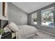 Bedroom with neutral walls, two large windows, and carpet flooring at 17336 E Rice Cir # F, Aurora, CO 80015