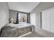 Bedroom with neutral walls, carpet flooring, and large window at 17336 E Rice Cir # F, Aurora, CO 80015