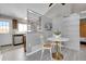 Dining area with a modern table, stylish chairs and barn door accent at 17336 E Rice Cir # F, Aurora, CO 80015