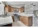 Kitchen featuring stainless steel appliances, dark wood cabinets, and granite counters at 17336 E Rice Cir # F, Aurora, CO 80015
