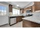 Kitchen featuring stainless steel appliances, dark wood cabinets, and granite counters at 17336 E Rice Cir # F, Aurora, CO 80015