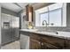 Kitchen featuring stainless steel appliances, dark wood cabinets, and granite counters at 17336 E Rice Cir # F, Aurora, CO 80015