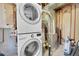 Utility room features stacked washer and dryer, hot water heater, and furnace at 17336 E Rice Cir # F, Aurora, CO 80015