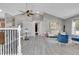 Bright living room featuring vaulted ceilings, modern flooring, and barn door with a seating area at 17336 E Rice Cir # F, Aurora, CO 80015