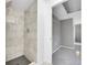 Modern shower featuring gray tile surround and black hexagon tile floor at 17336 E Rice Cir # F, Aurora, CO 80015