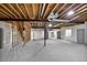 Unfinished basement ready for customization, showing exposed beams and concrete flooring at 16283 Olive Way, Brighton, CO 80602