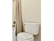 Bathroom featuring a standard toilet, shower over tub and tiled walls at 16283 Olive Way, Brighton, CO 80602