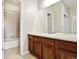 Bathroom featuring a single sink, large mirror and a shower over tub at 16283 Olive Way, Brighton, CO 80602