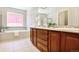 This bathroom has a double sink vanity with a soaking tub and shower at 16283 Olive Way, Brighton, CO 80602