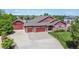 Stunning exterior elevation of this home with three-car garage, lush landscaping, and expansive driveway at 16283 Olive Way, Brighton, CO 80602