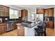 Gourmet kitchen features an island with bar seating, stainless steel appliances, and granite countertops at 16283 Olive Way, Brighton, CO 80602