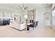 Open concept living room featuring a fireplace, tray ceilings, neutral colors and lots of light at 16283 Olive Way, Brighton, CO 80602